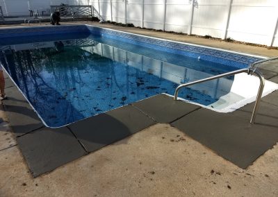 New concrete around a renovated pool.