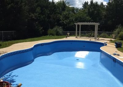 A sunny day with a pool that had a liner replacement service done by our team.